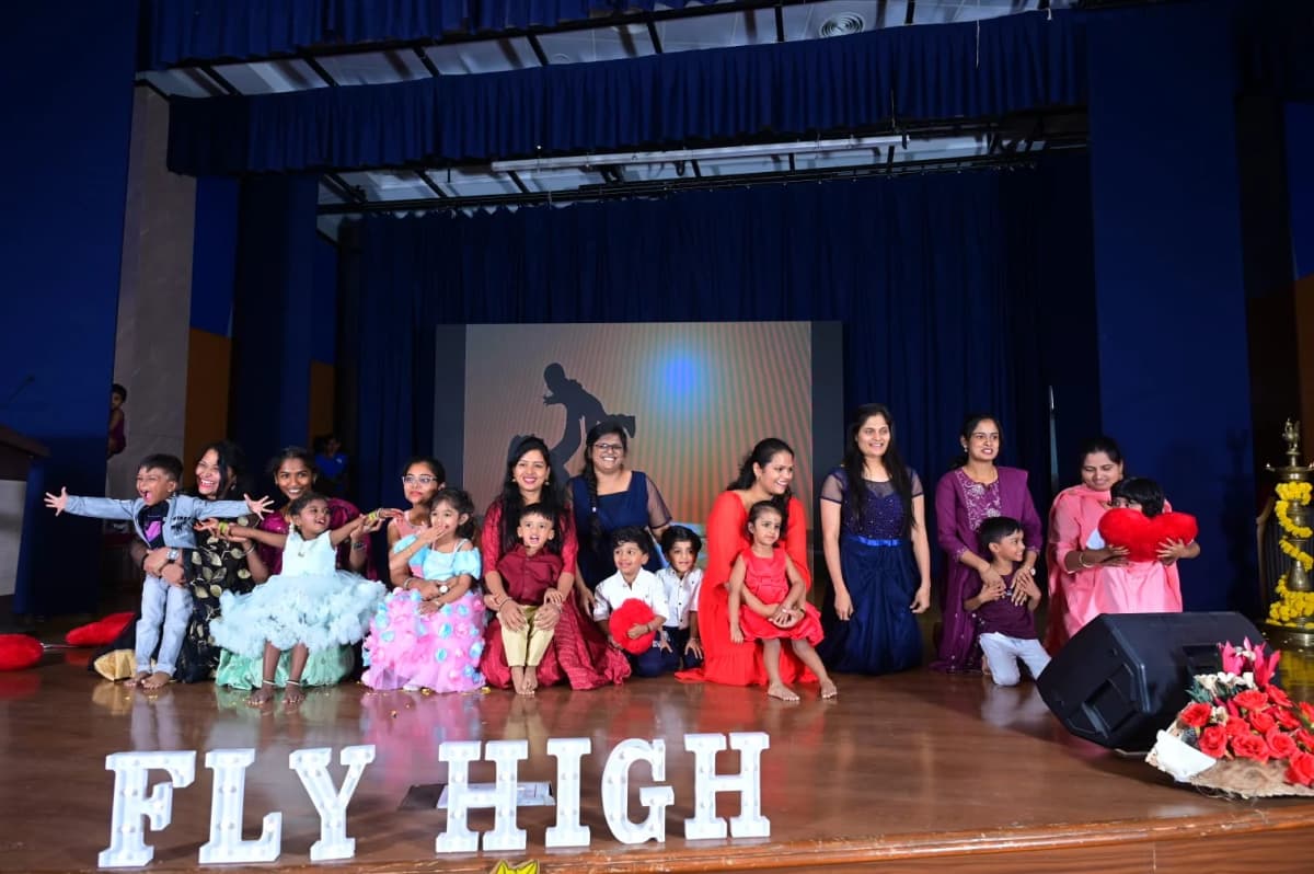 Cast group photo on stage at FlyHigh