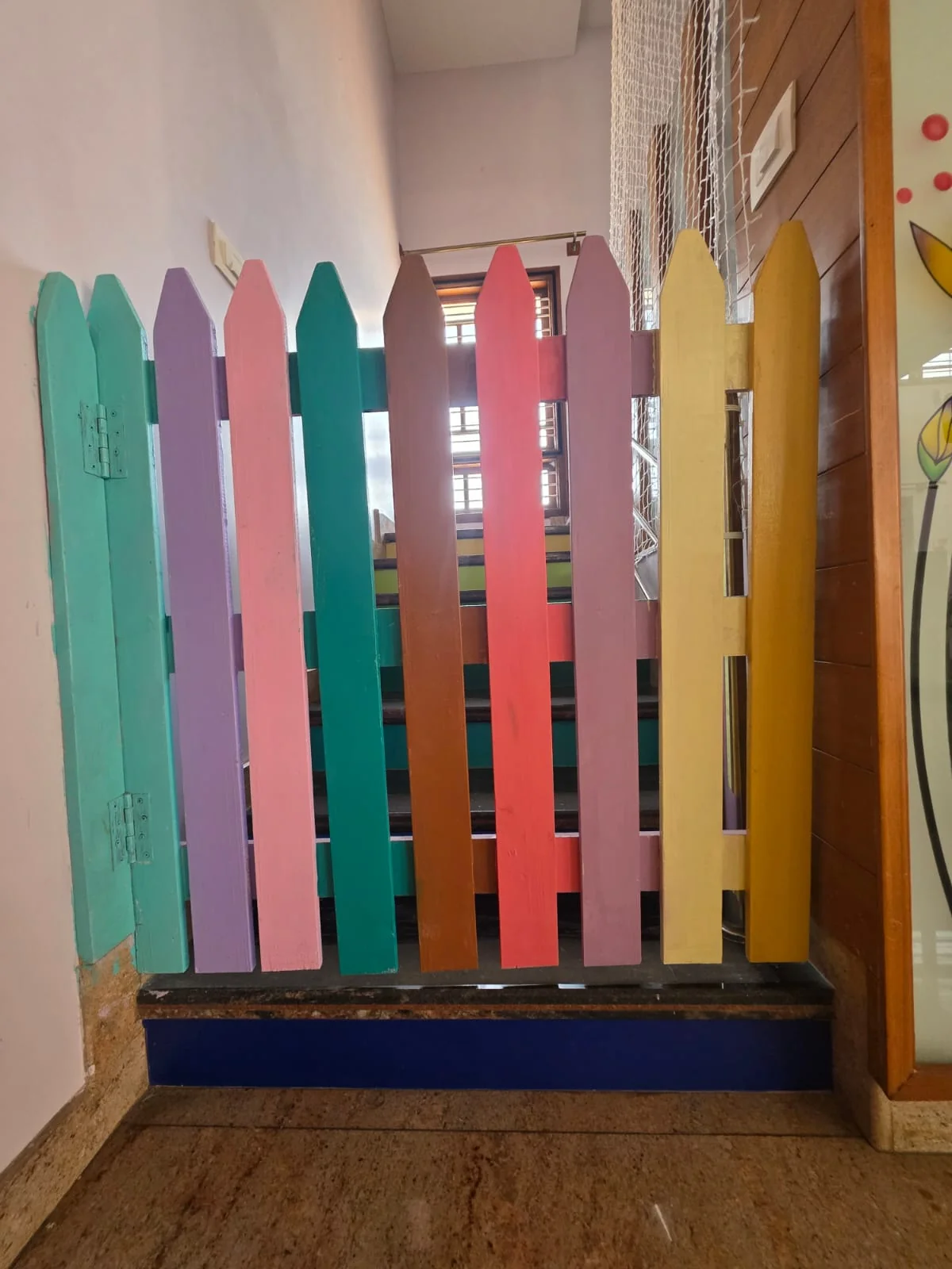 Child-safe wooden gate at top of stairs at FlyHigh